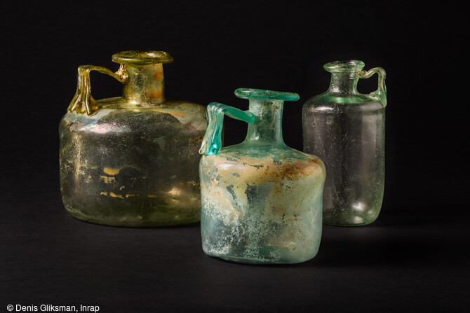 Bouteilles cylindriques en verre, trouv&eacute;es avec les restes osseux br&ucirc;l&eacute;s d'un d&eacute;funt, dans un coffre en pierre d&eacute;couvert dans la n&eacute;cropole antique de Narbonne (Aude) en 2019.