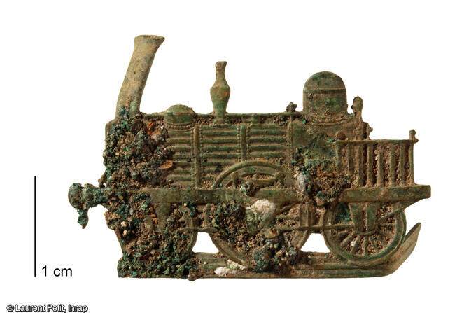 Applique repr&eacute;sentant une locomotive mise au jour lors de la fouille de l'ancienne gare du Pecq (Yvelines) en 2017. Elle provenait tr&egrave;s probablement de l'habit d'un employ&eacute; de la gare. 