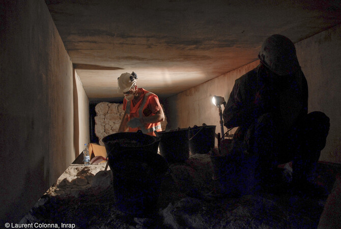 Arch&eacute;ologues en cours de fouille entre deux poutres de la plateforme du tramway au niveau de la tour Pairoli&egrave;re &agrave; Nice (Alpes-Maritimes) en 2007. 