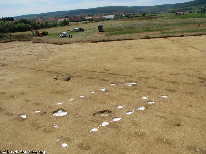 En blanc apparaissent les trous de poteaux formant l'ossature d'un b&acirc;timent dat&eacute; du N&eacute;olithique. L'alignement de fosses rectangulaires correspond aux traces laiss&eacute;es par un vignoble gallo-romain. Gevrey-Chambertin (C&ocirc;tes-d'Or), 2008.&nbsp;