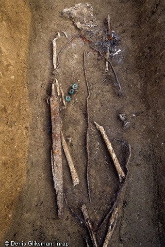 Détail d'une épée et d'un bouclier dont il ne reste que la gouttière périphérique, ou  orle , et le renfort central, IVe s. avant notre ère, Buchères (Aube), 2013.  